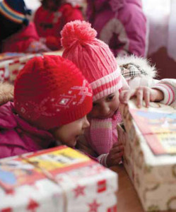 Two little girls in Romania cannot wait to see what has been packed in their shoeboxes.