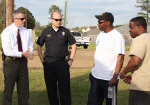 Chief Thompson and a fellow officer visiting with residents of the Riverbend neighborhood in Byram