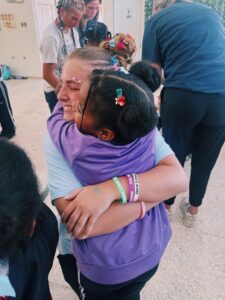 UNCROPPED_ Young woman hugging a little girl