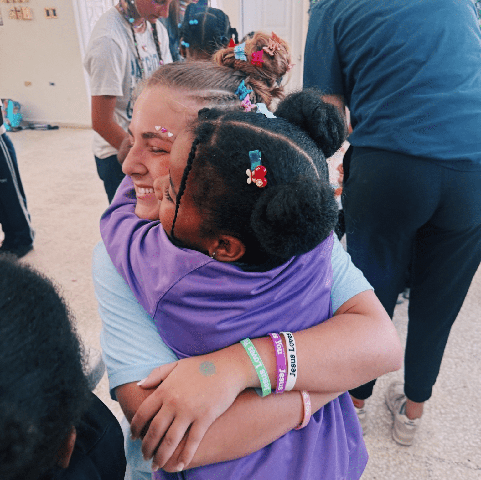 Young woman hugging a little girl