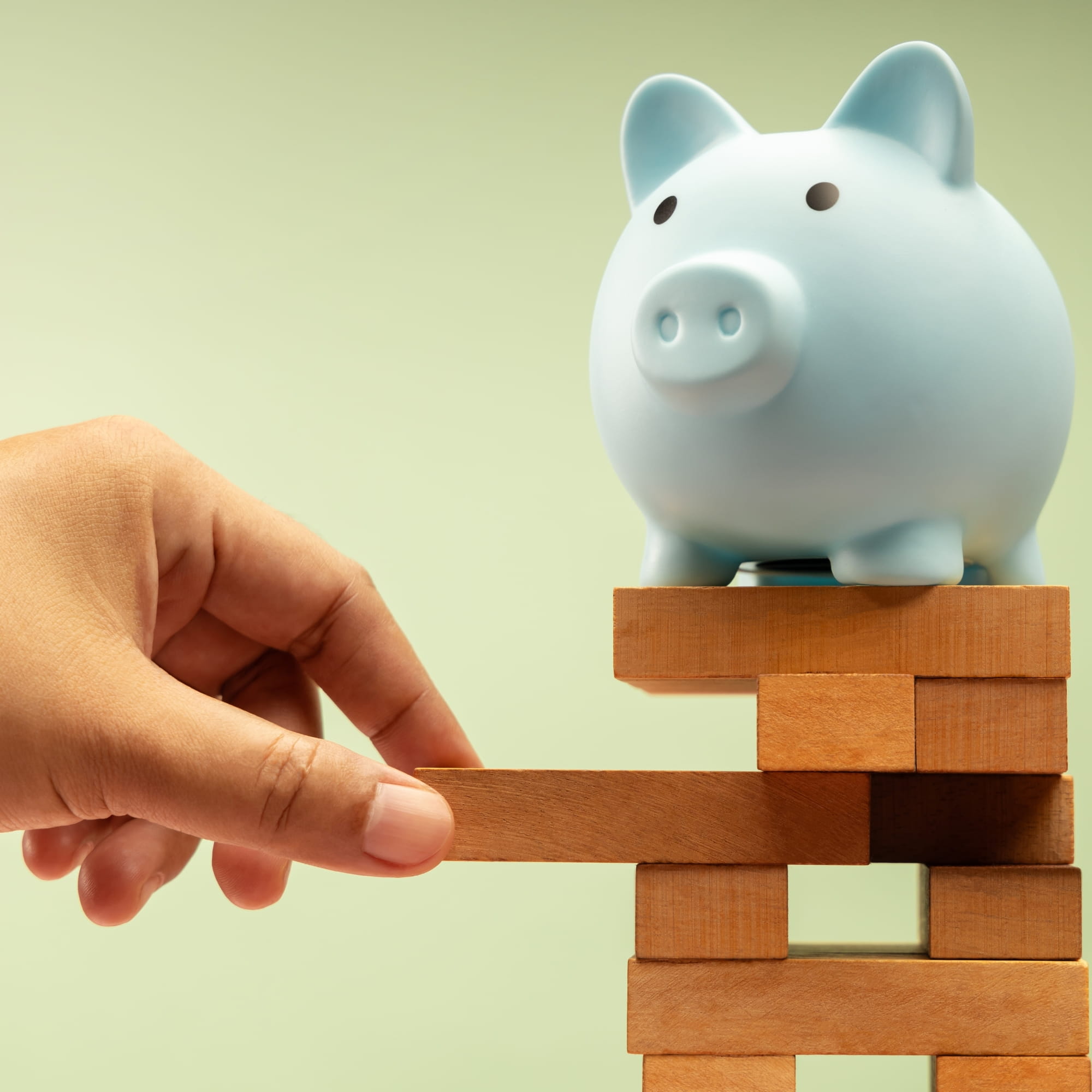 Piggy bank on top of Jenga game