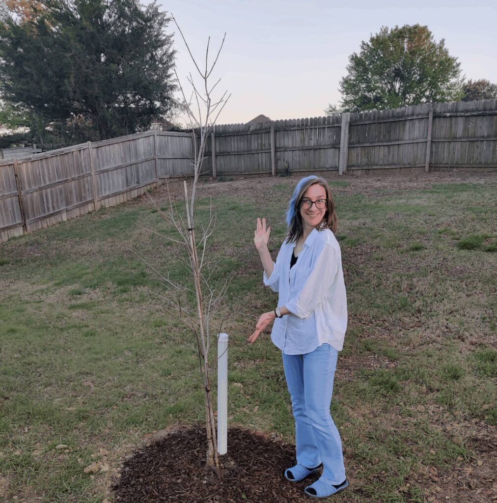 Katie Ginn with a newly planted maple